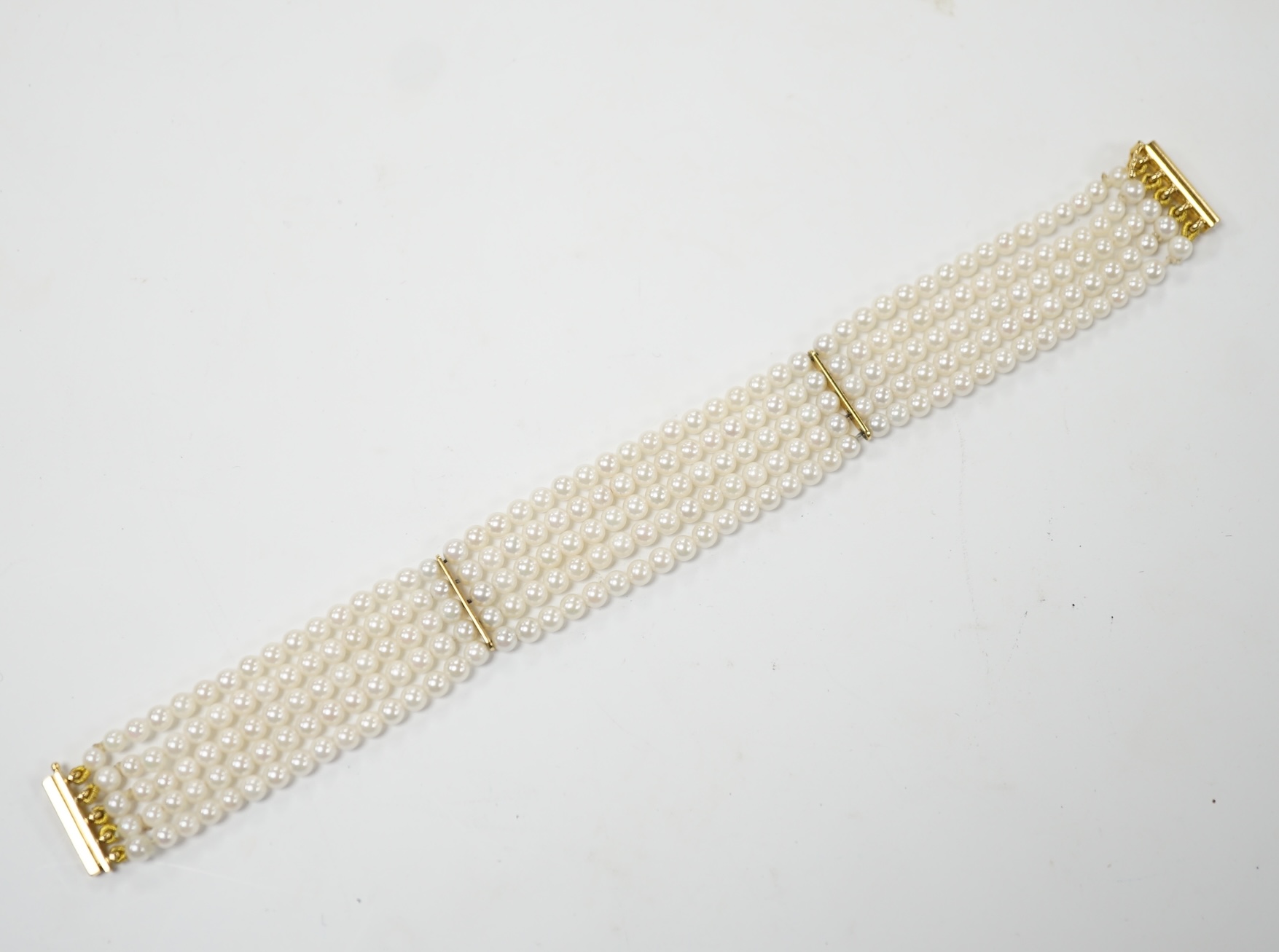 A modern multi-strand cultured pearl bracelet, with 18ct gold clasp, 17cm, gross weight 16.3 grams. Good condition.